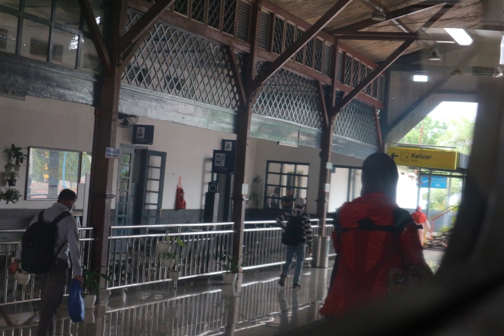 a group of people standing outside of a train station