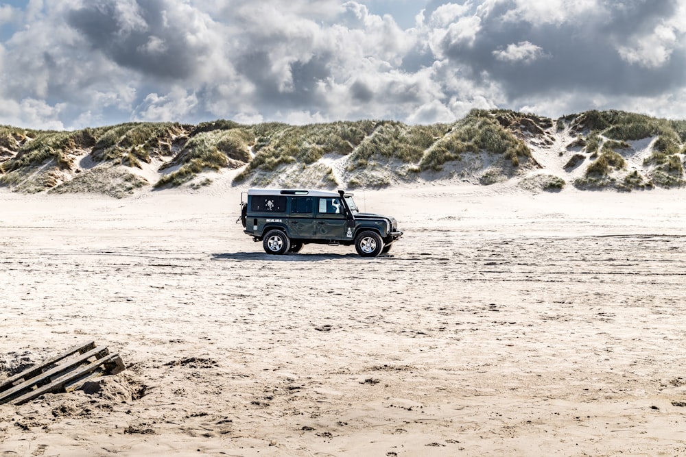 a truck is parked on a sandy beach