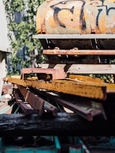 a rusted train car sitting on top of a pile of junk