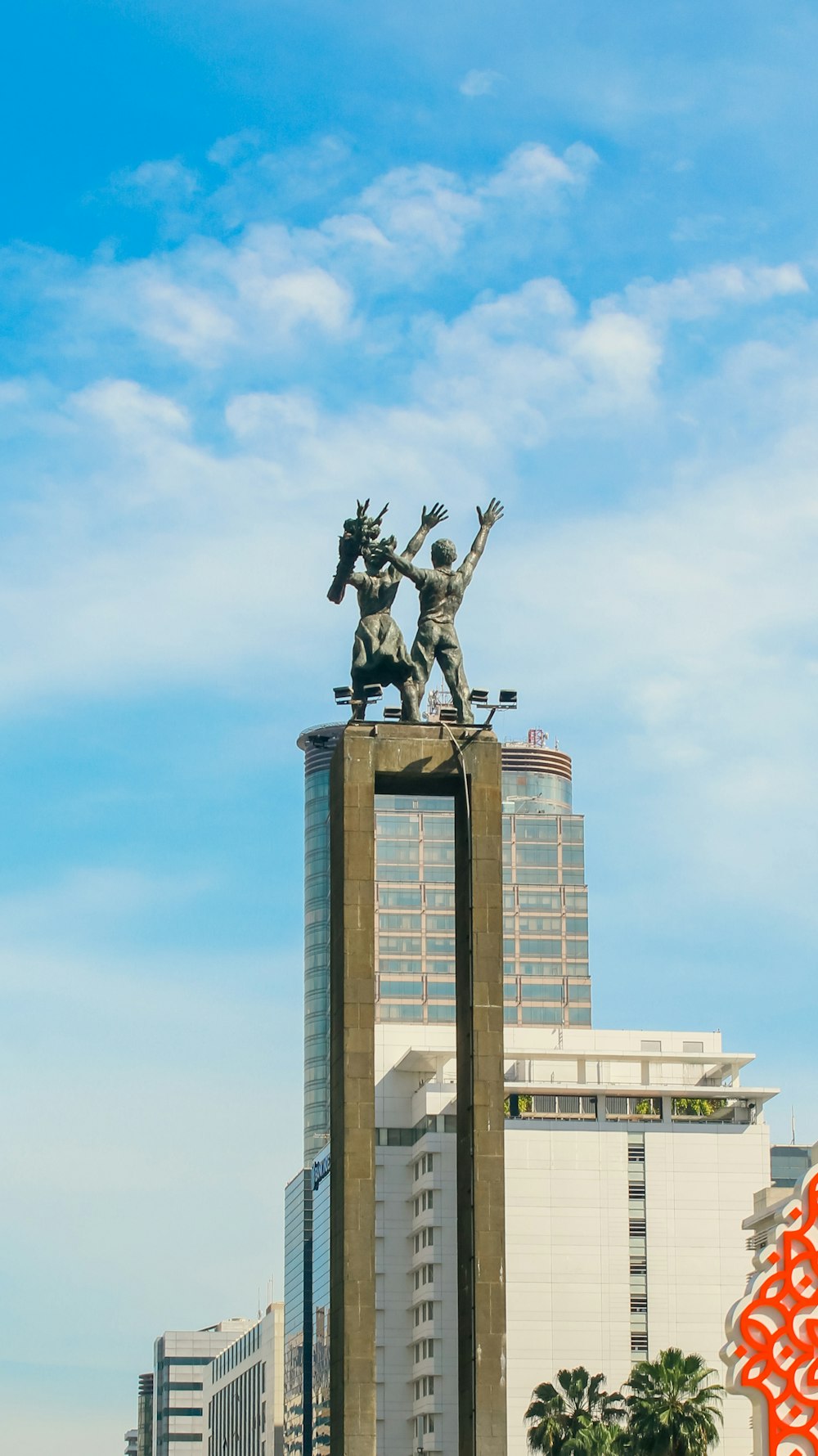 a statue of a man riding a horse in front of a tall building