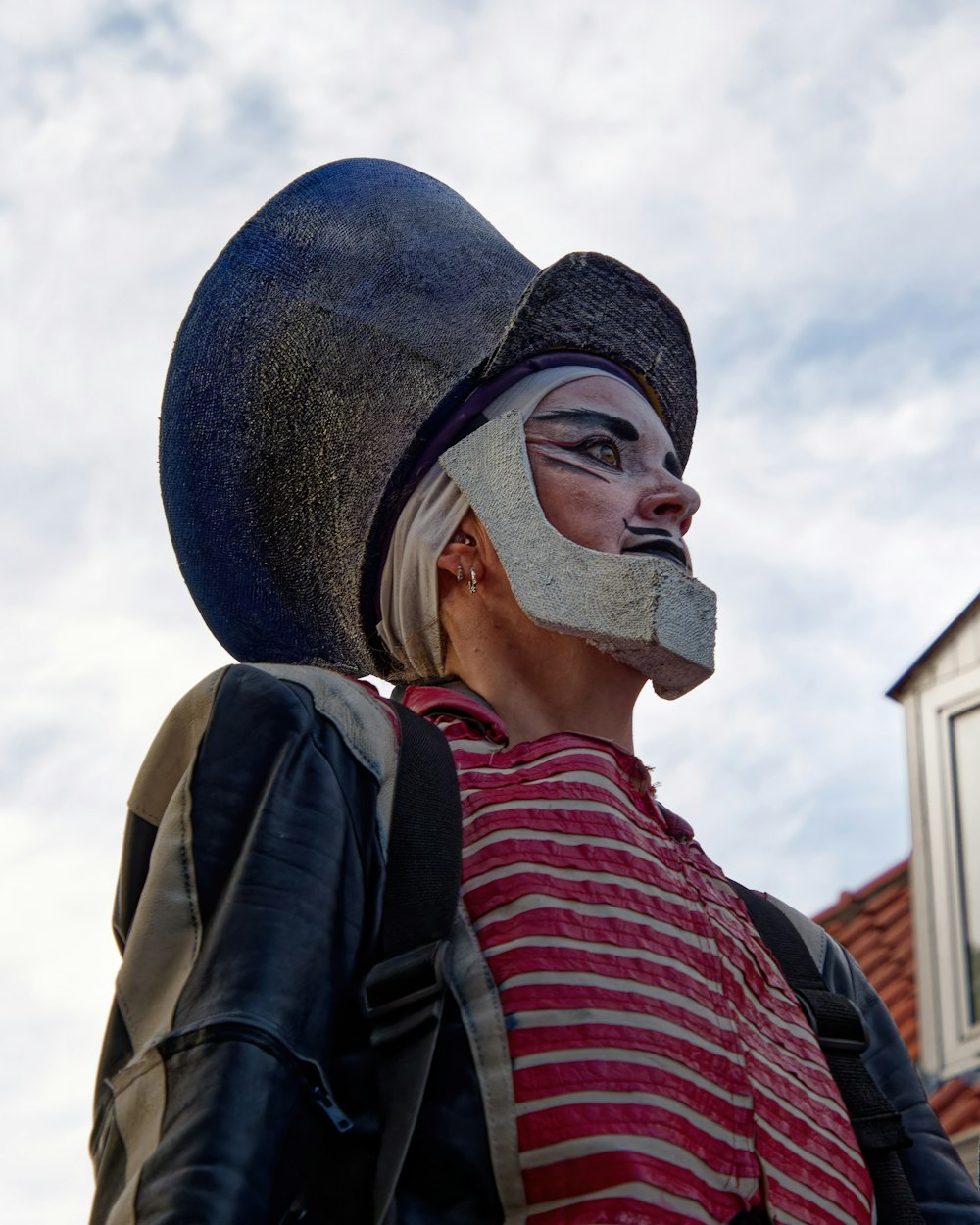 a statue of a man wearing a hat and a striped shirt