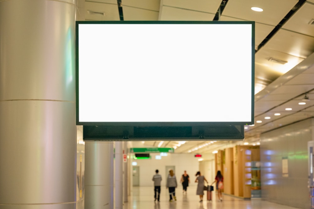 a large white sign hanging from the side of a building