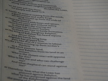 Close-up of a page from a printed book. The text is in English and appears to be a passage discussing various subjects related to a great army attacking Babylon. The page is well-lit, with the text predominantly in black on a white background. The right side of the page features a dotted line pattern.