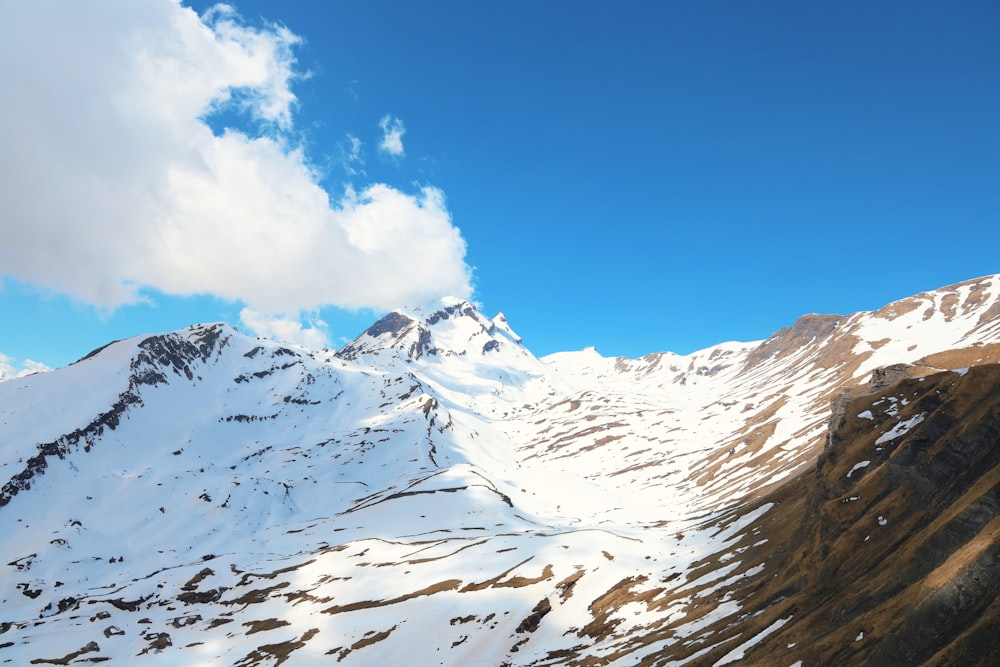 a mountain covered in snow under a blue sky