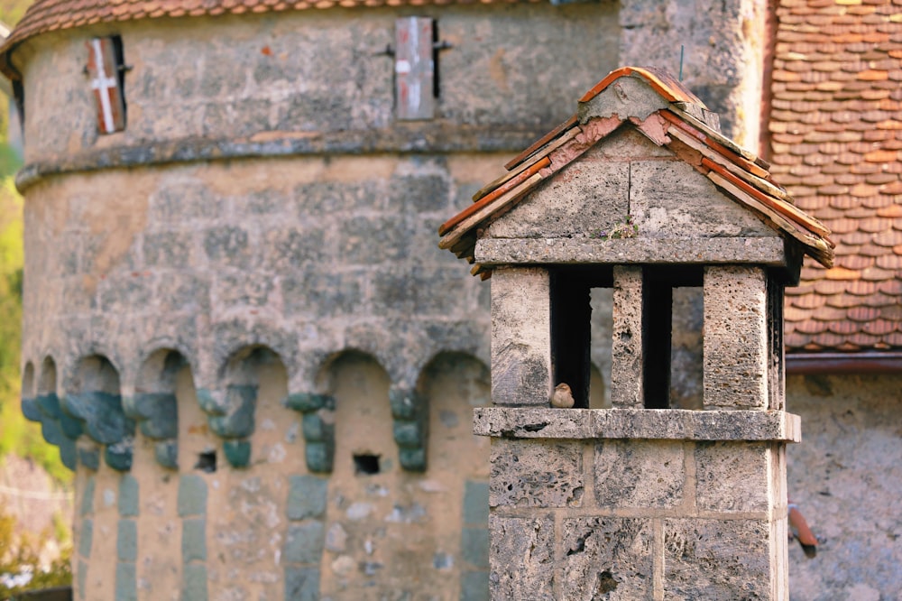 a stone tower with a clock on the top of it