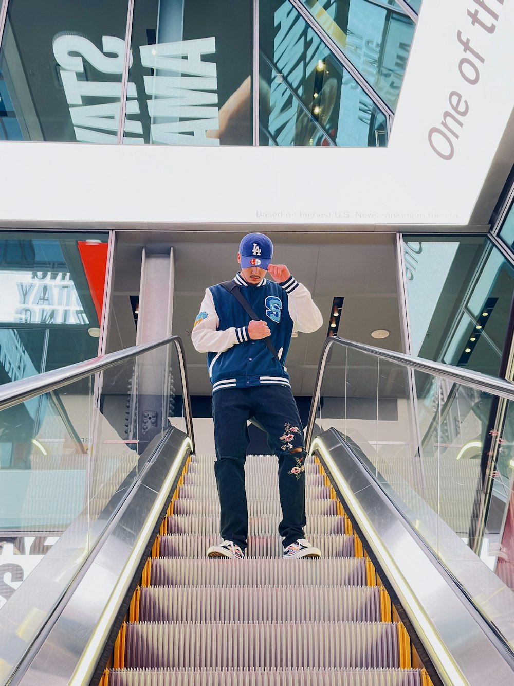 a man standing on an escalator in front of a building