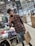Portrait of a happy customer holding shopping bags inside a clothing store.