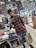 Portrait of a happy customer holding shopping bags inside a clothing store.