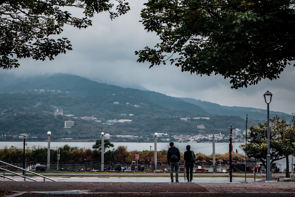 a couple of people walking down a street