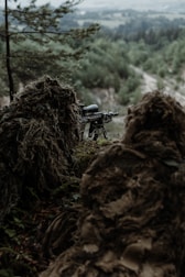 a rifle on a tripod in the woods