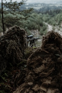 a rifle on a tripod in the woods