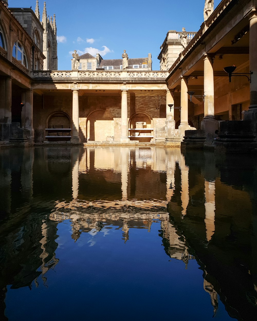 a reflection of a building in a pool of water