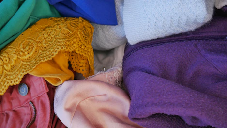 A pallet stacked with assorted clothing and fashion accessories.