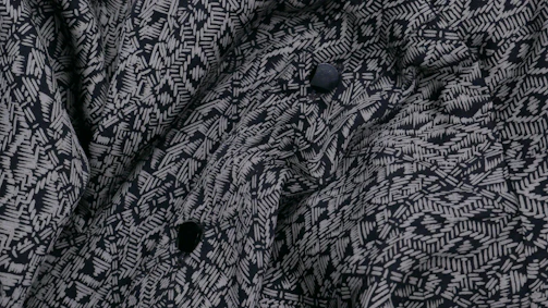 Close-up of a digital clothing pattern displayed on a computer screen in a modern studio