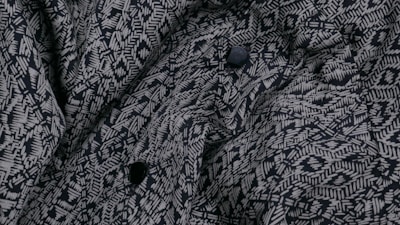 A close-up of intricate fabric patterns on a designer shirt.