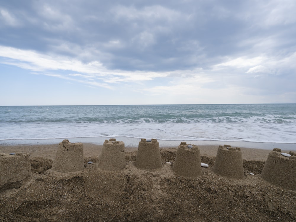 a sand castle on the beach with the ocean in the background