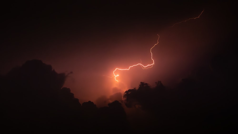 a lightning bolt is seen in the night sky