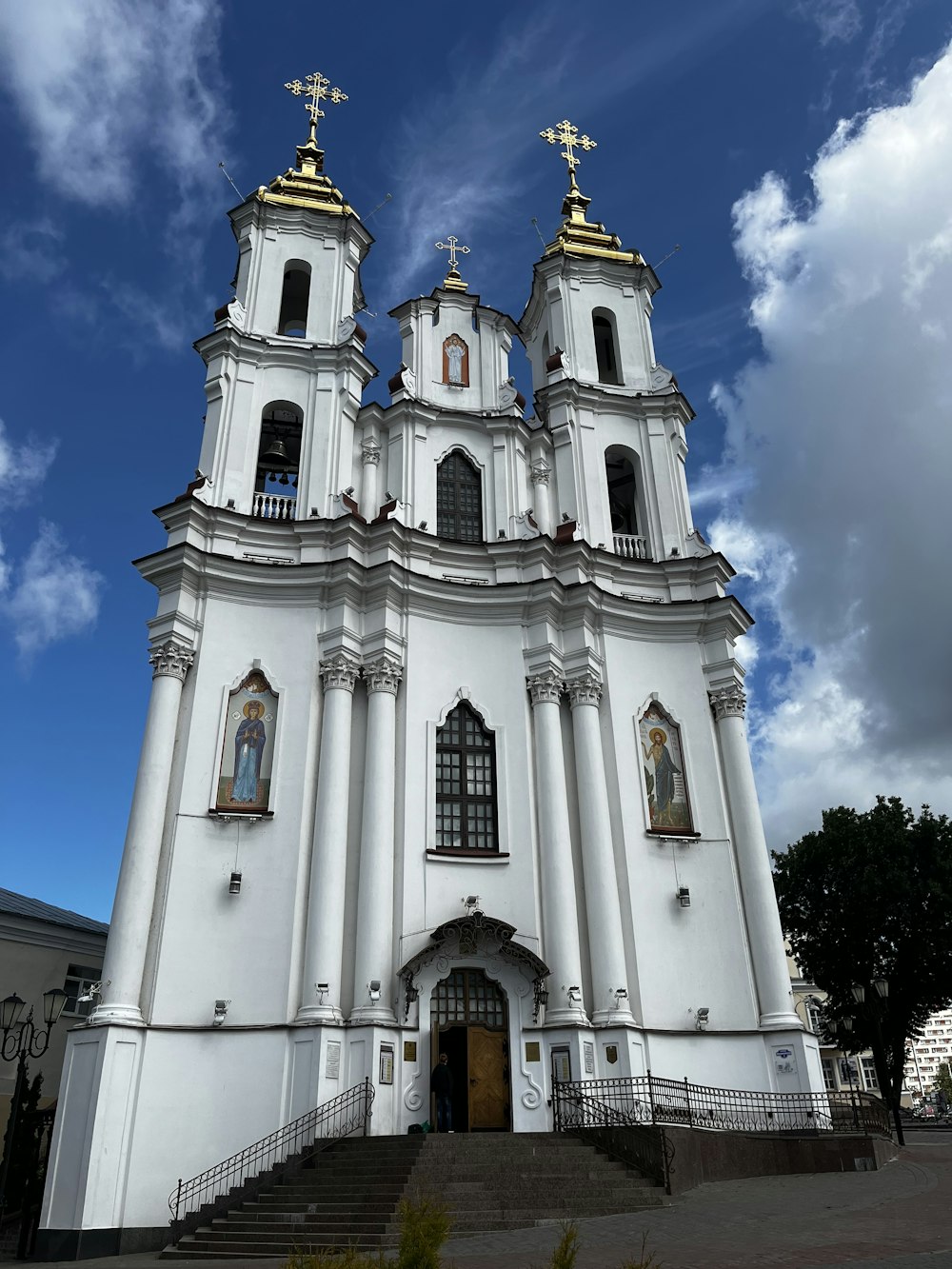 a large white church with two golden crosses on top of it