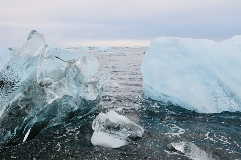 two icebergs floating in the water near each other