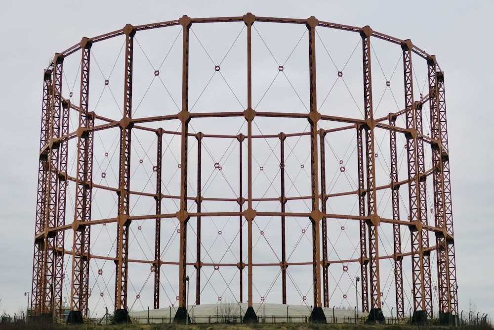 a large metal structure sitting on top of a field