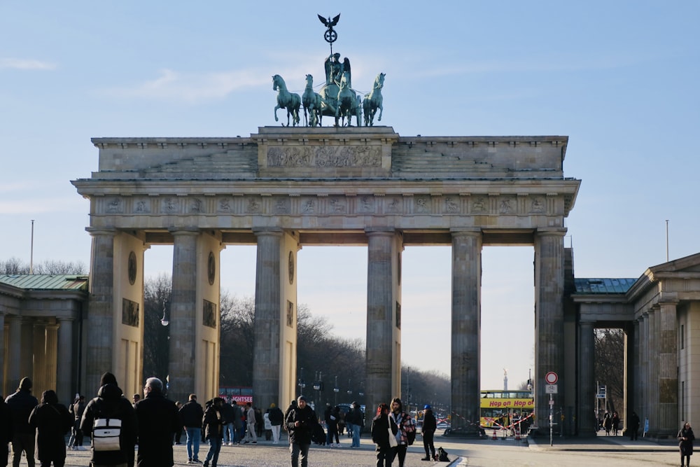 a group of people walking in front of a monument