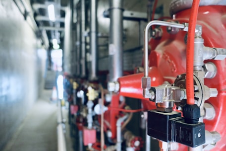 a close up of pipes and valves in a building
