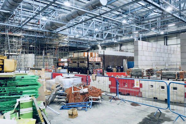 A busy warehouse filled with scaffolding and construction tools ready for hire.