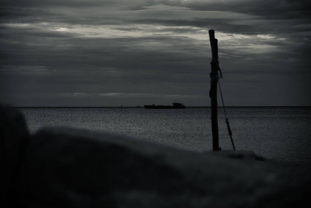 a black and white photo of a boat in the ocean