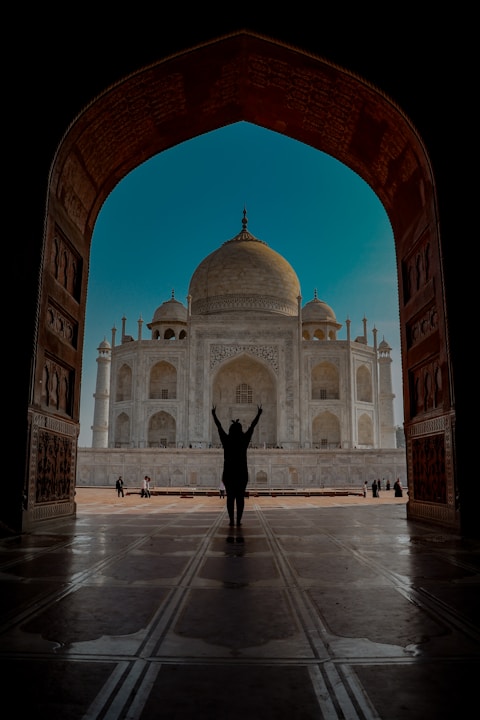 a person standing in front of a white building