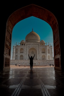a person standing in front of a white building