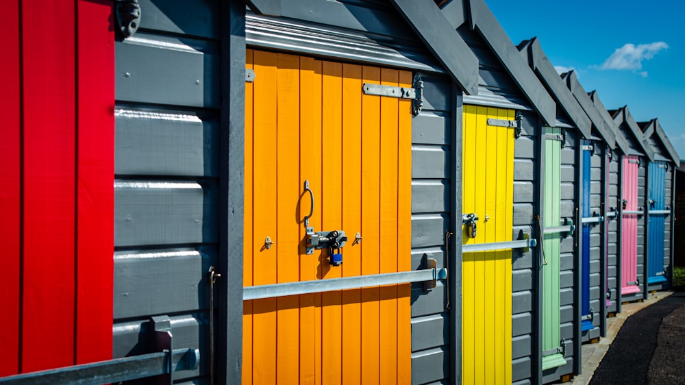 a row of multicolored beach huts sitting next to each other