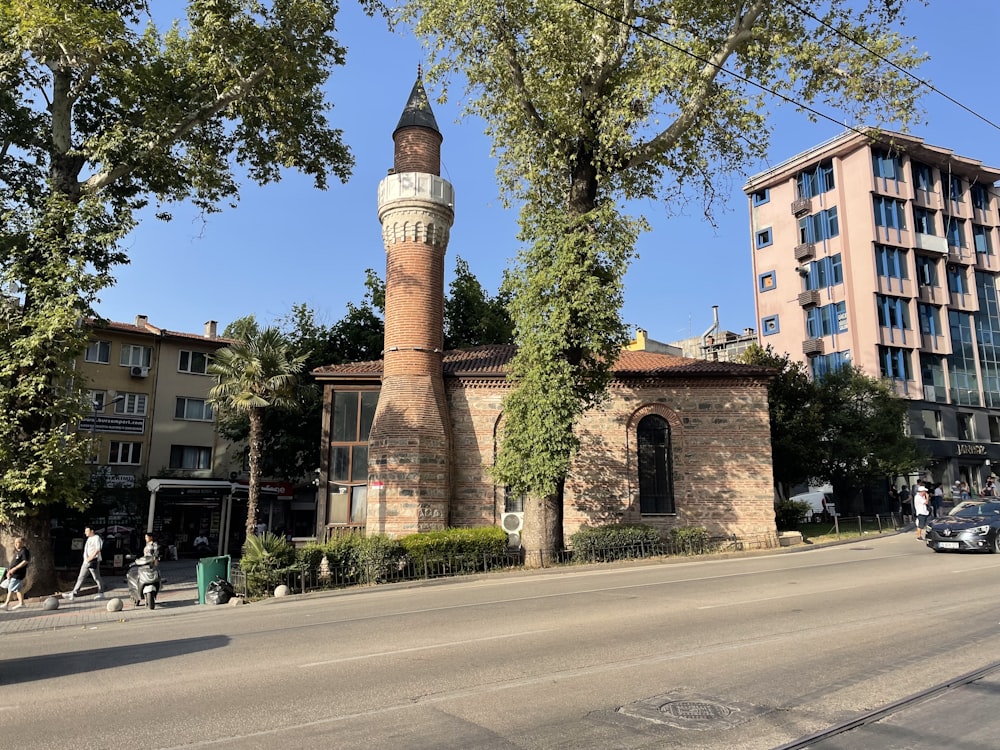 a tall brick building sitting on the side of a road