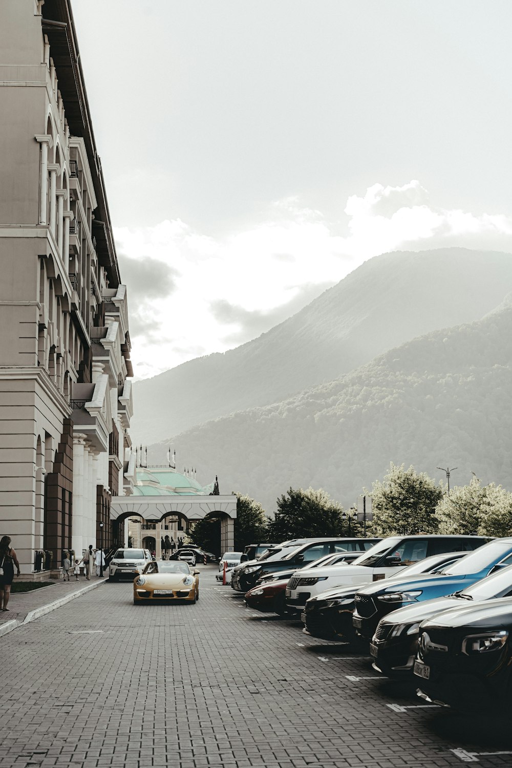 a row of parked cars sitting on the side of a road