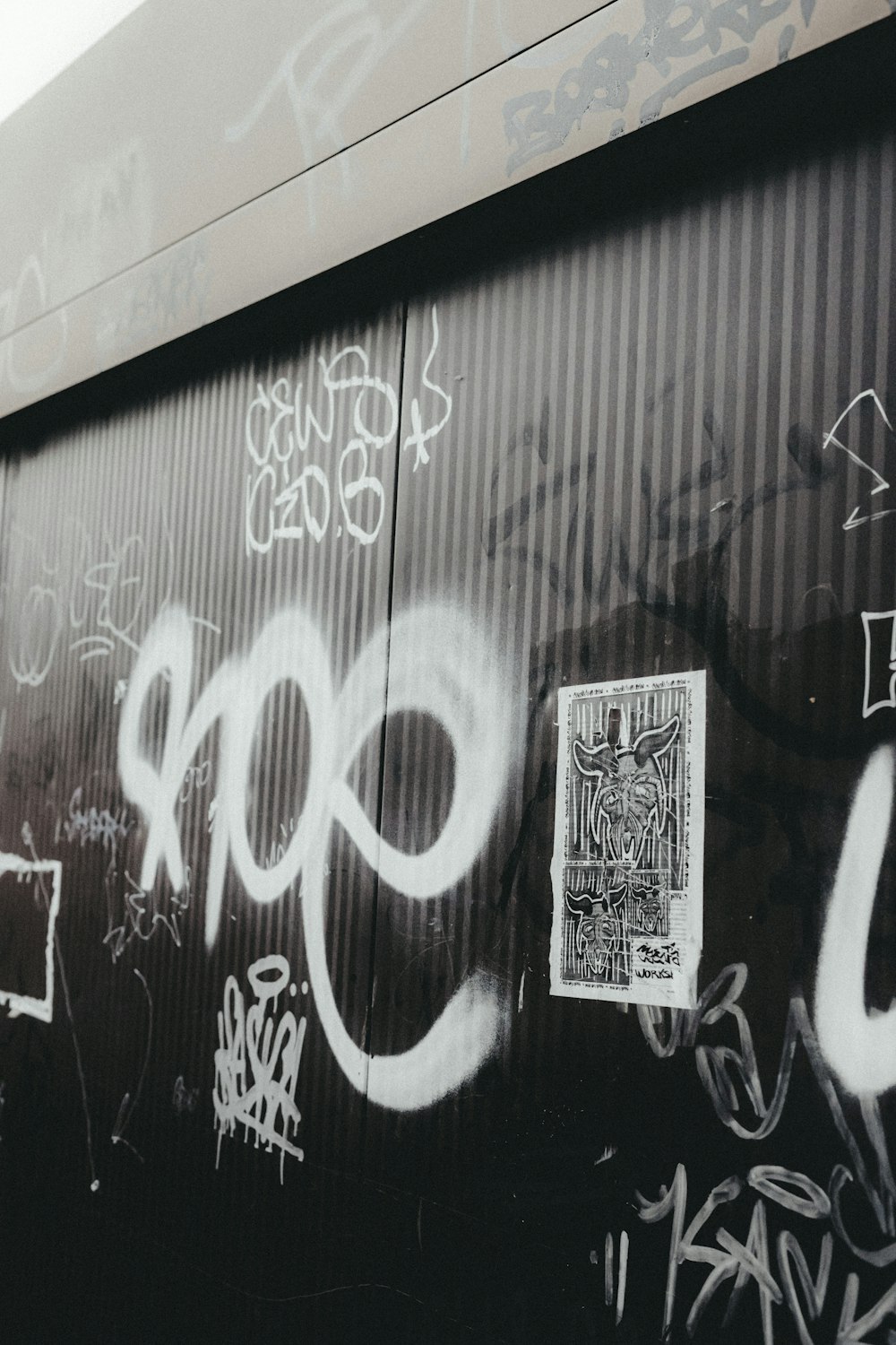 a train car covered in graffiti next to a wall