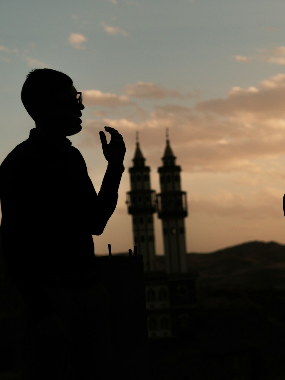 a silhouette of a man and a woman standing next to each other