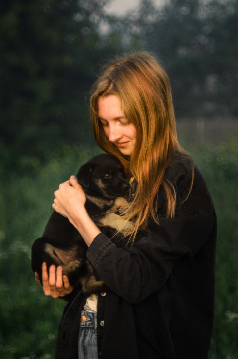 a woman holding a cat in her arms