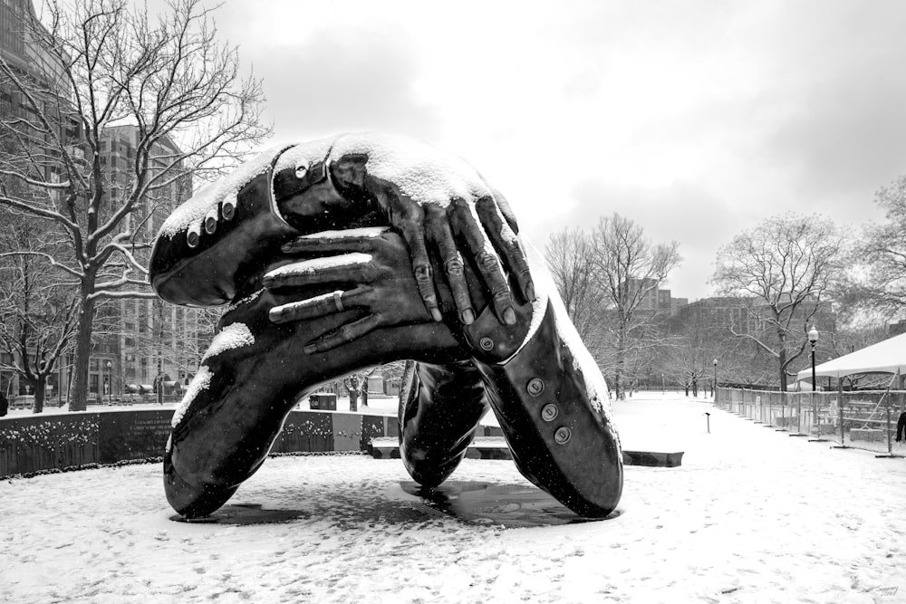 a sculpture of a baseball glove in the snow