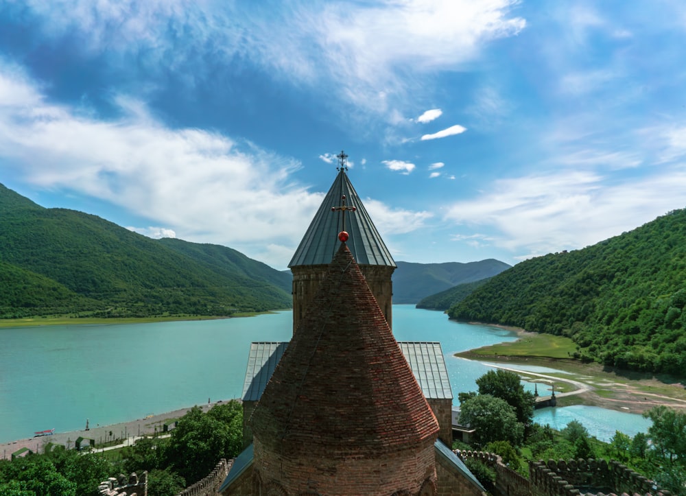 a church tower with a lake in the background