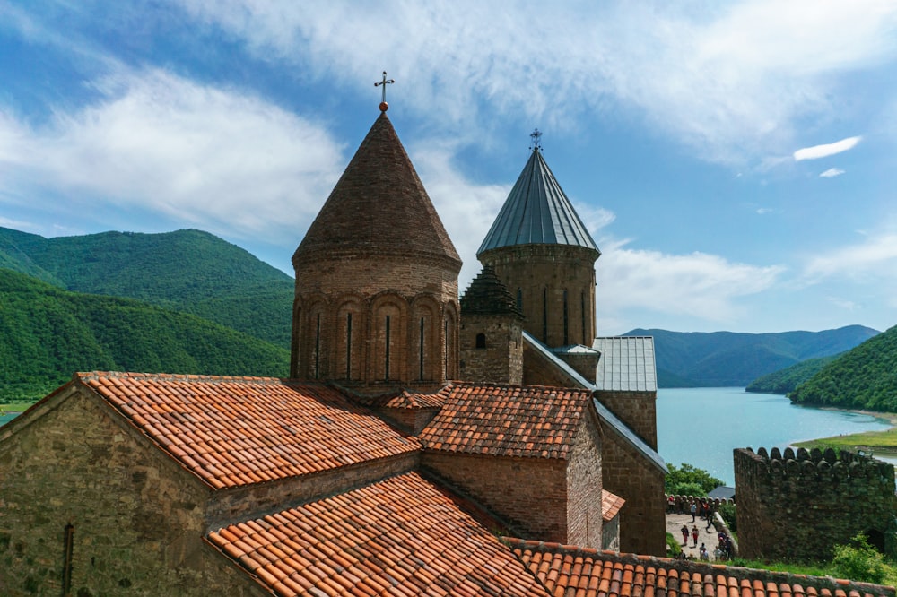 a view of a church with a lake in the background