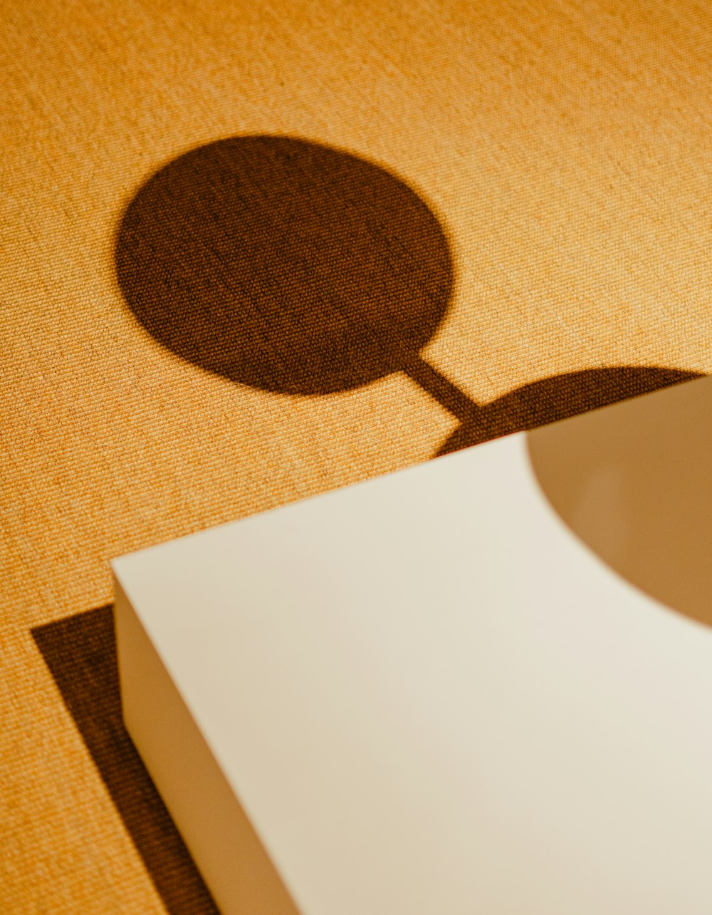 a shadow of a round object on a table