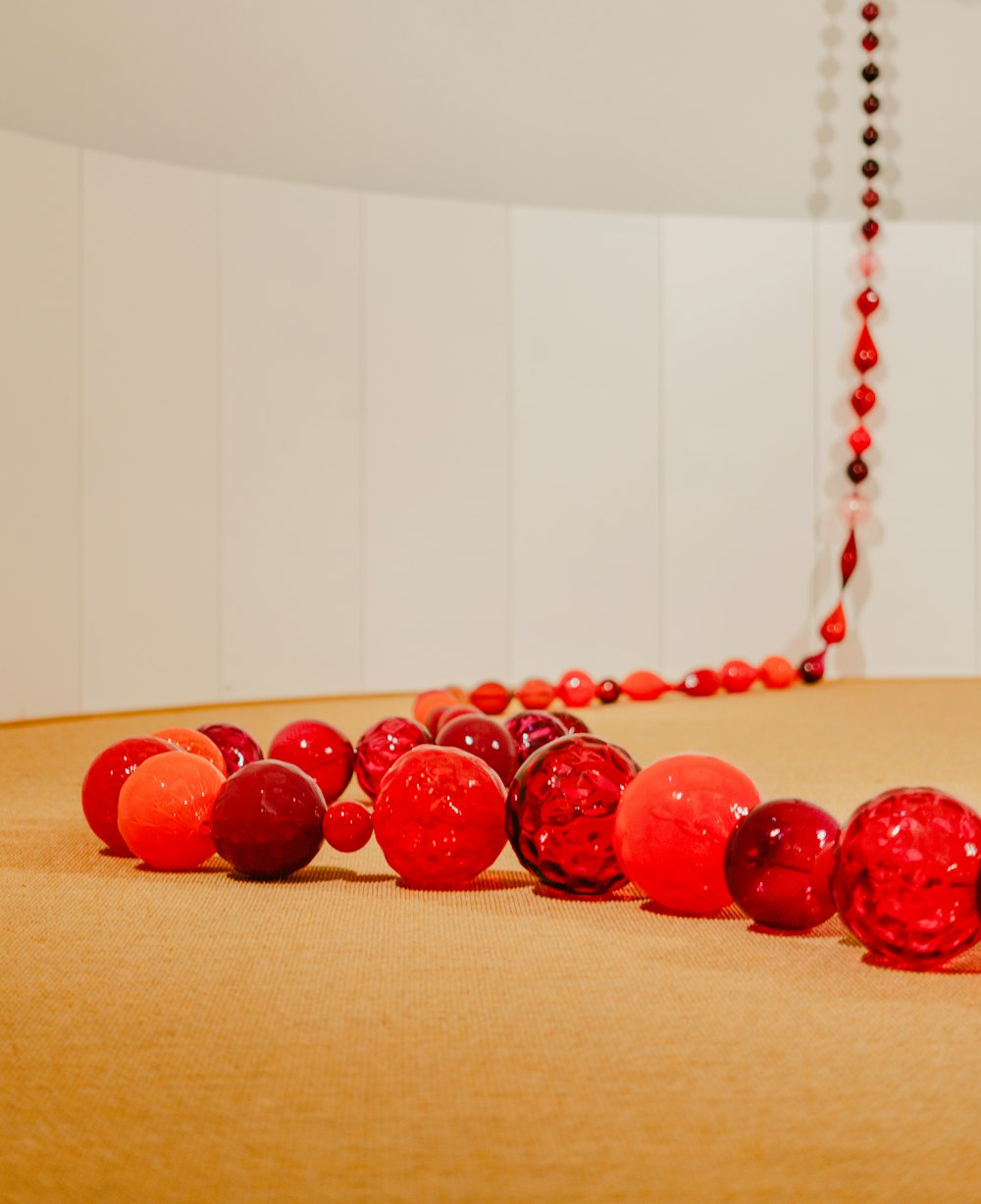 a group of red balls sitting on top of a table