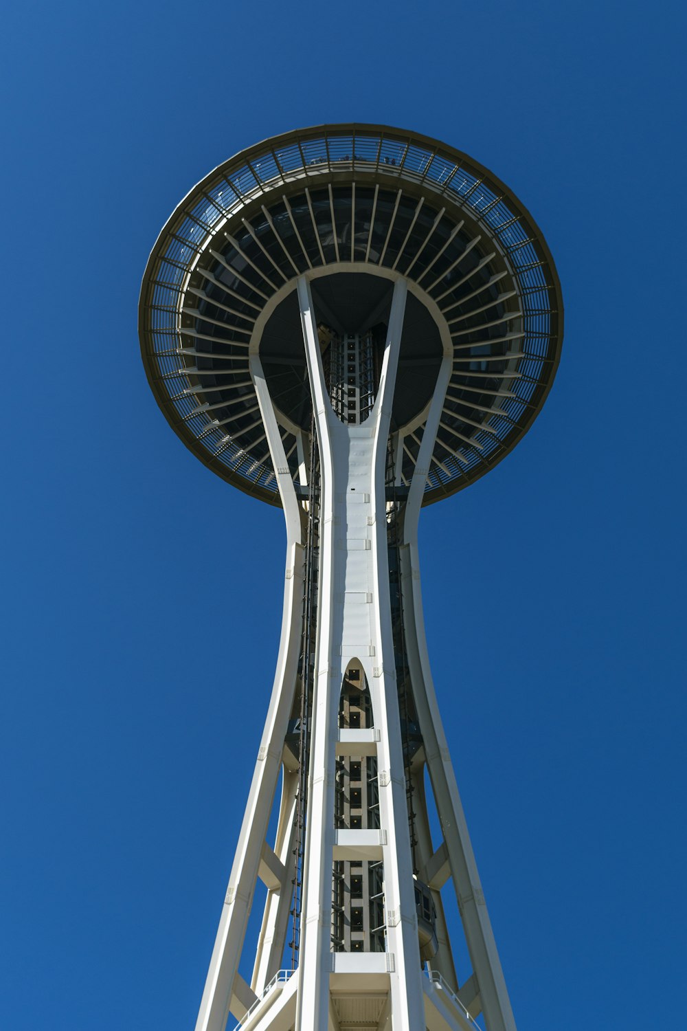 a tall white tower with a blue sky in the background