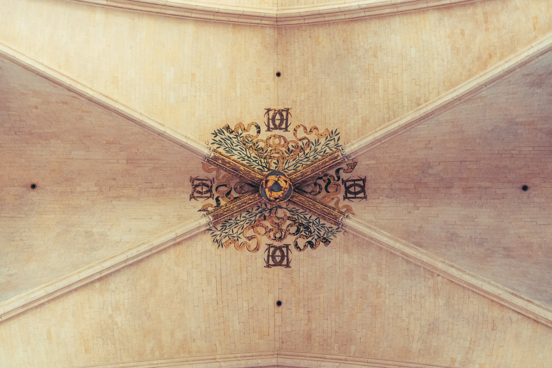 the ceiling of a building with a clock on it
