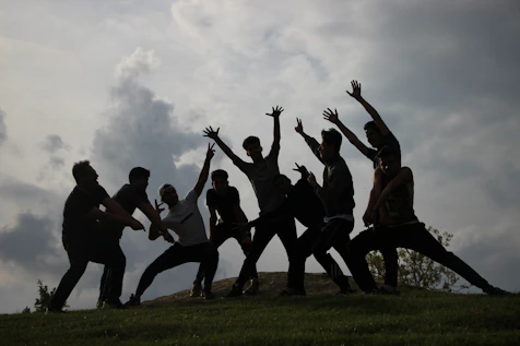 a group of people standing on top of a lush green field