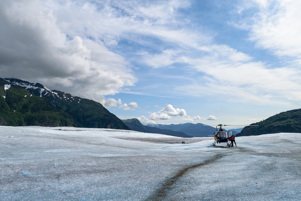 a helicopter sitting on top of a snow covered field