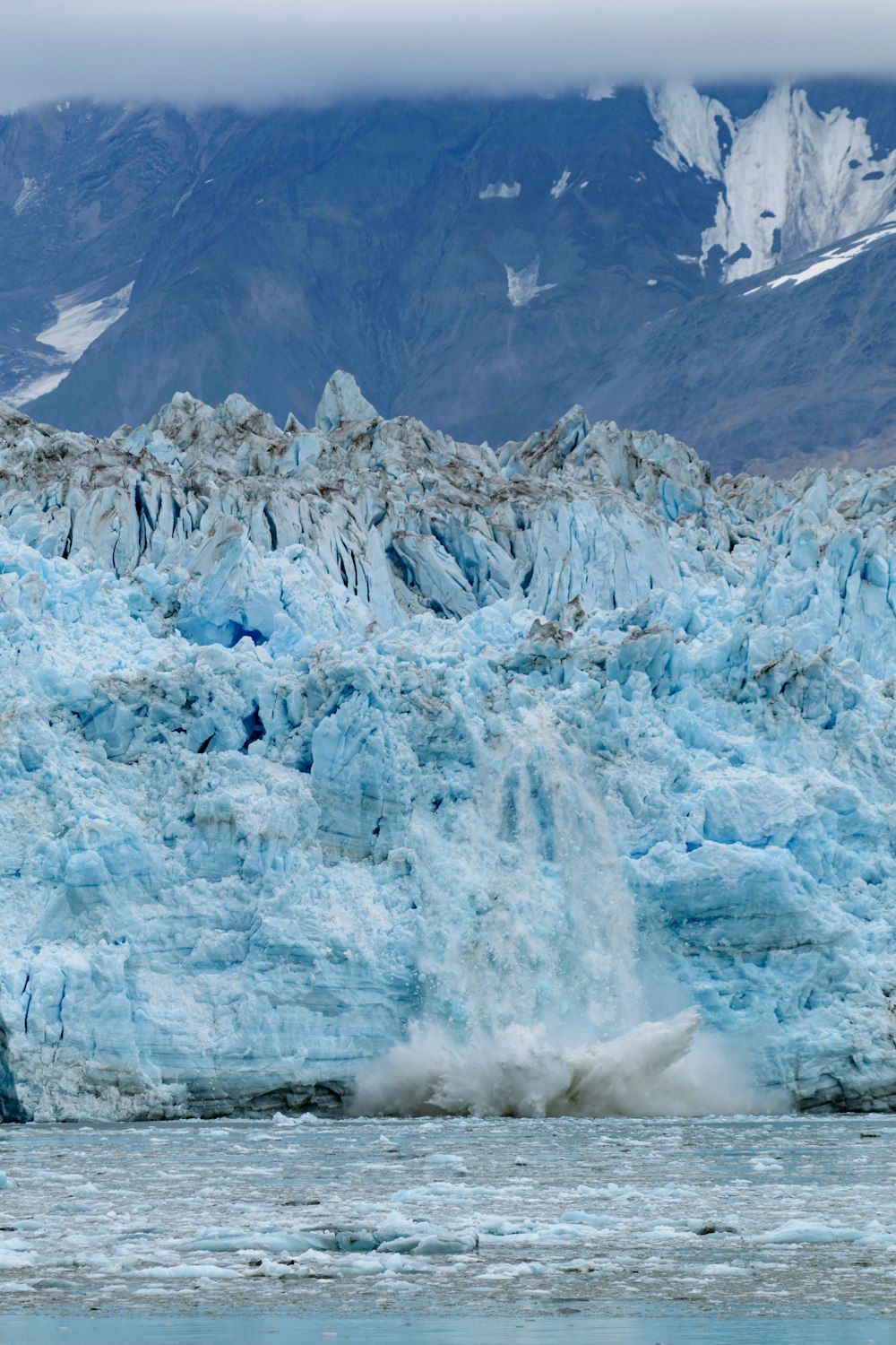 a large iceberg in the middle of a body of water