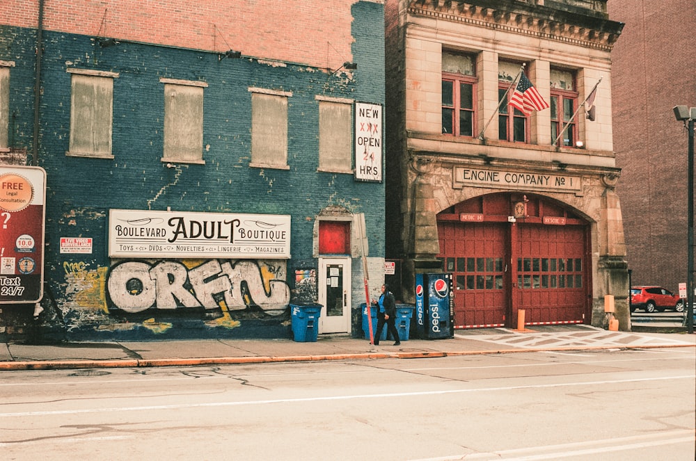 a couple of people standing in front of a building