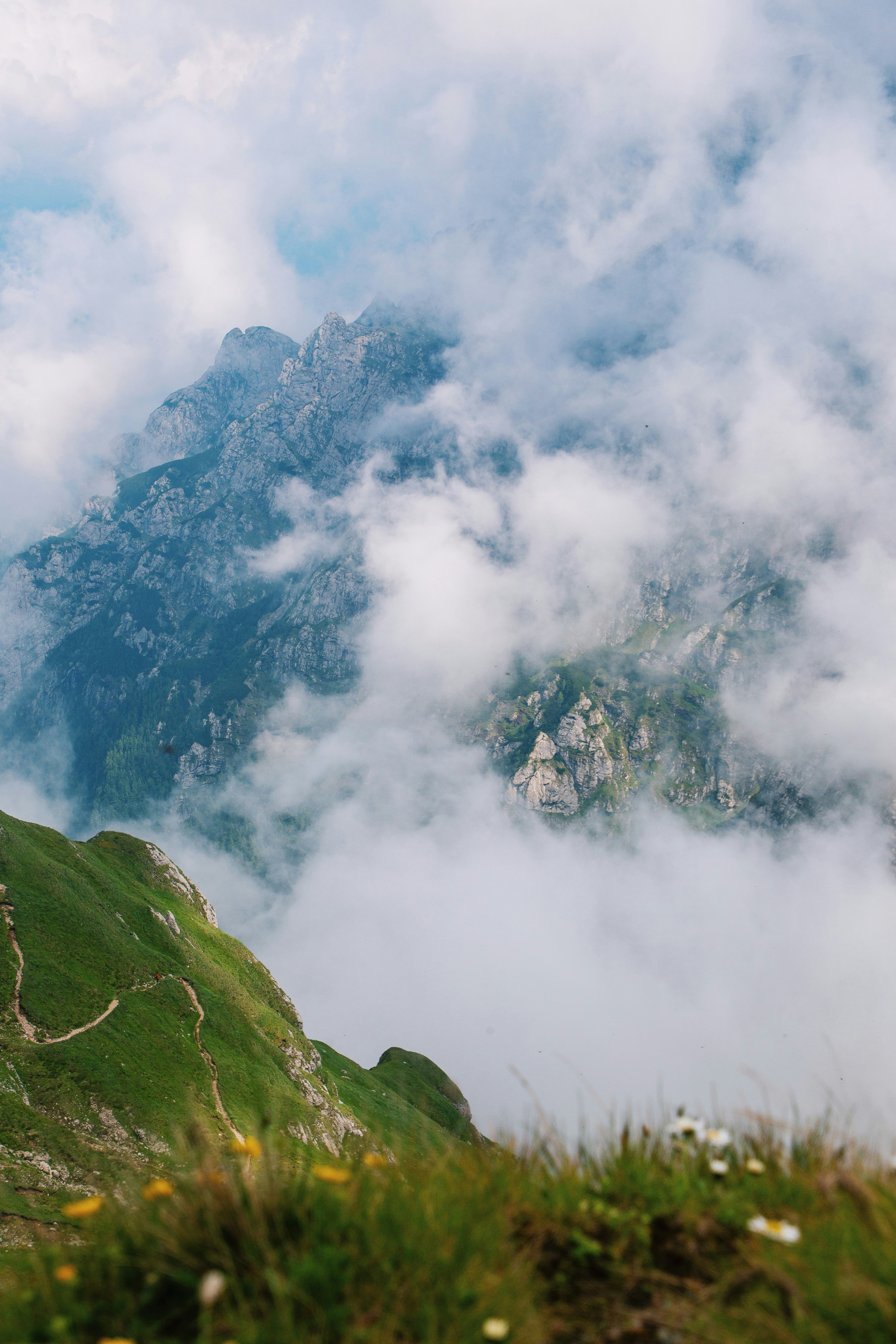 a view of a mountain with clouds in the sky