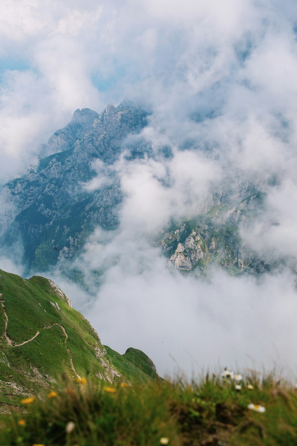 a view of a mountain with clouds in the sky