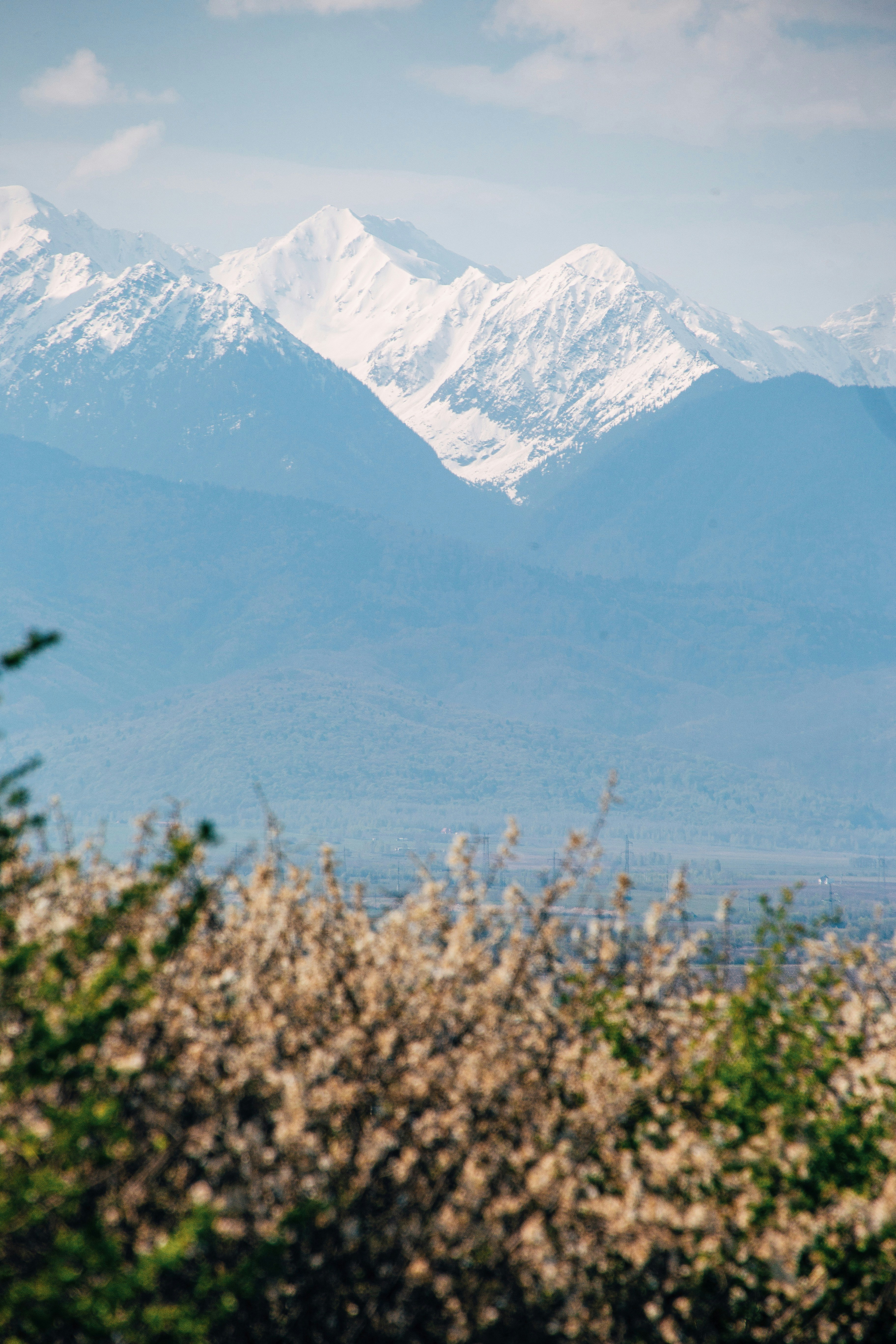 a mountain range with snow capped mountains in the background
